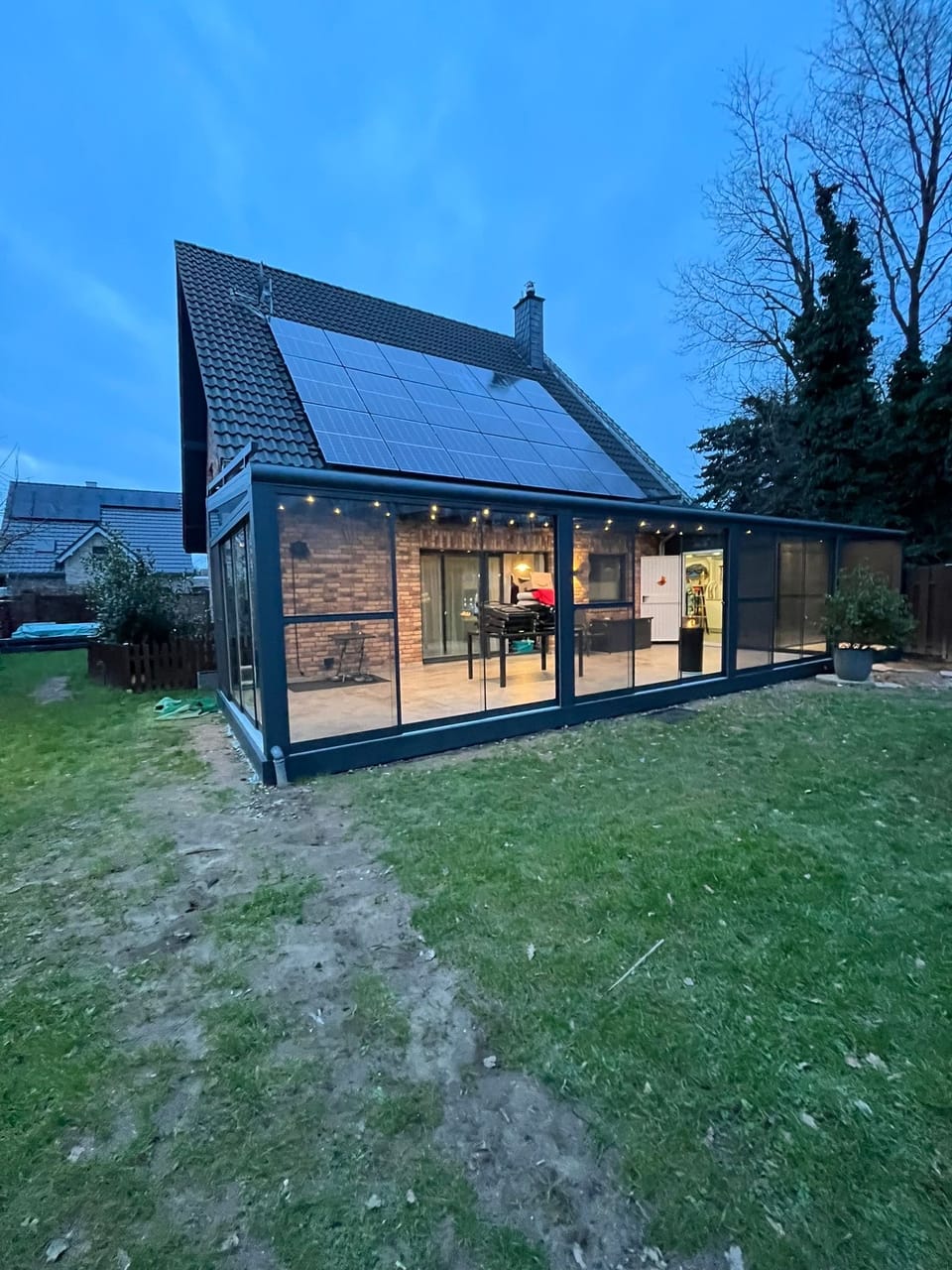 Terrassendach mit VSG-Klarglas und Glaselementen am Klinkerhaus